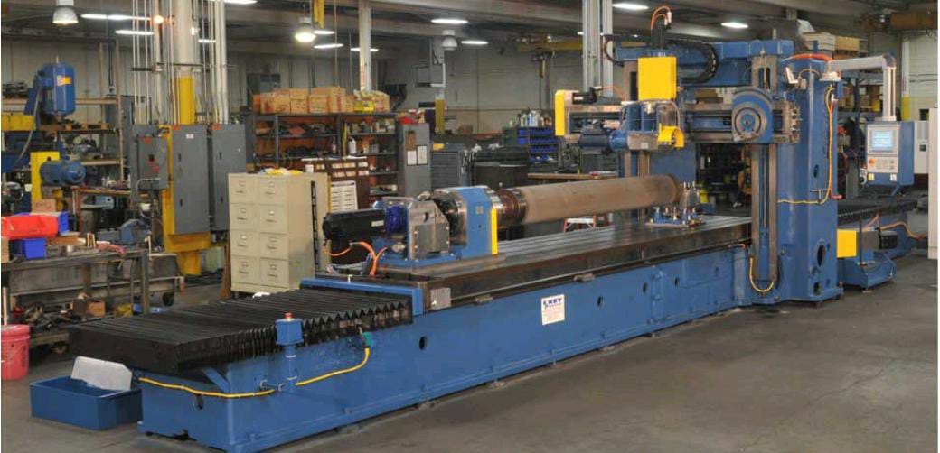 A worker operates a grinder cutting metal, creating a vibrant display of sparks in an industrial setting.