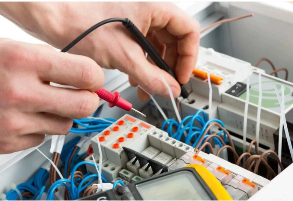 A worker operates a grinder cutting metal, creating a vibrant display of sparks in an industrial setting.