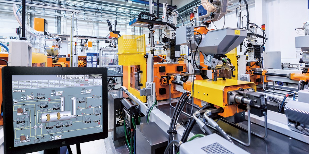 A worker operates a grinder cutting metal, creating a vibrant display of sparks in an industrial setting.